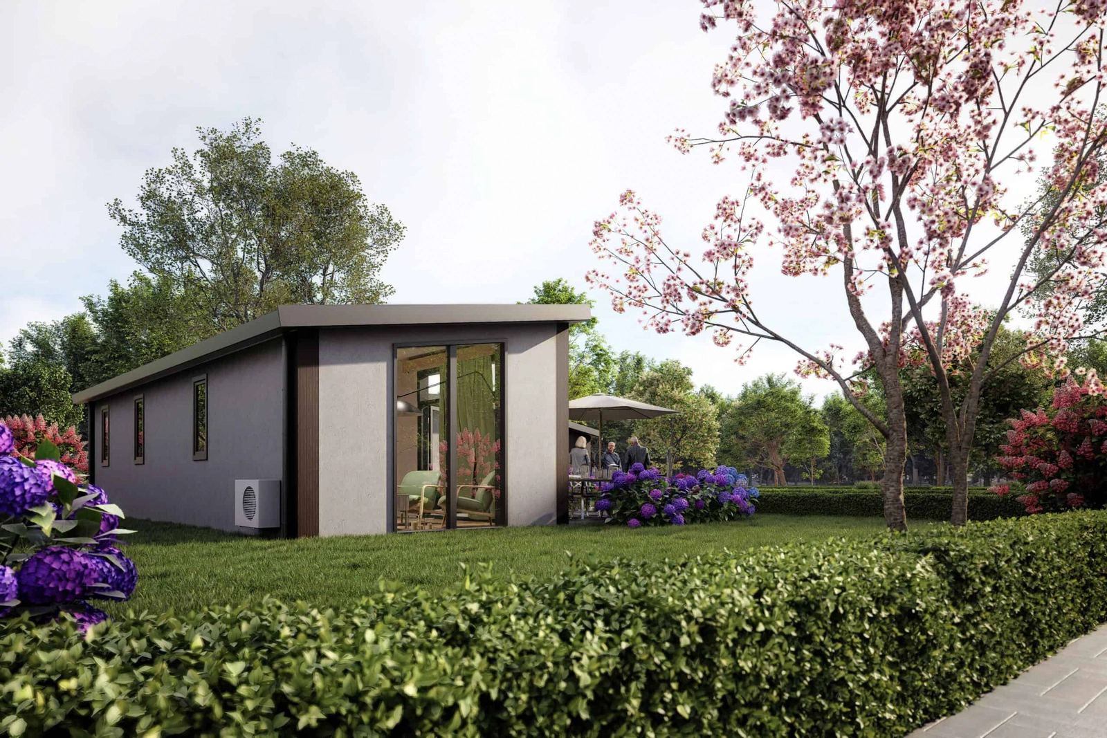 Opgeleverde mantelzorgwoning in een tuin met bloeiende boom